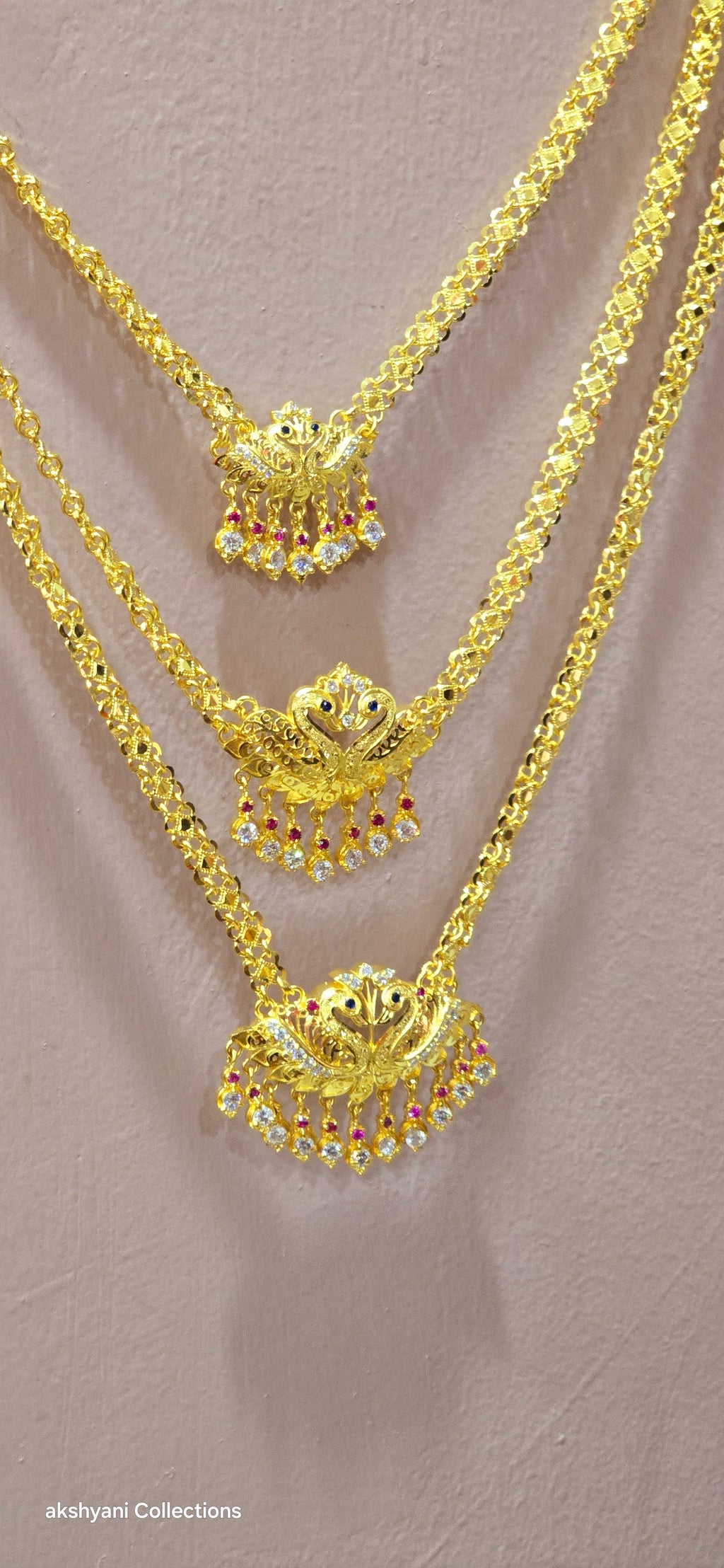 3 layer pendent chain not 916 gold. 28 inches length with decked peacock brooch. Code 808A.