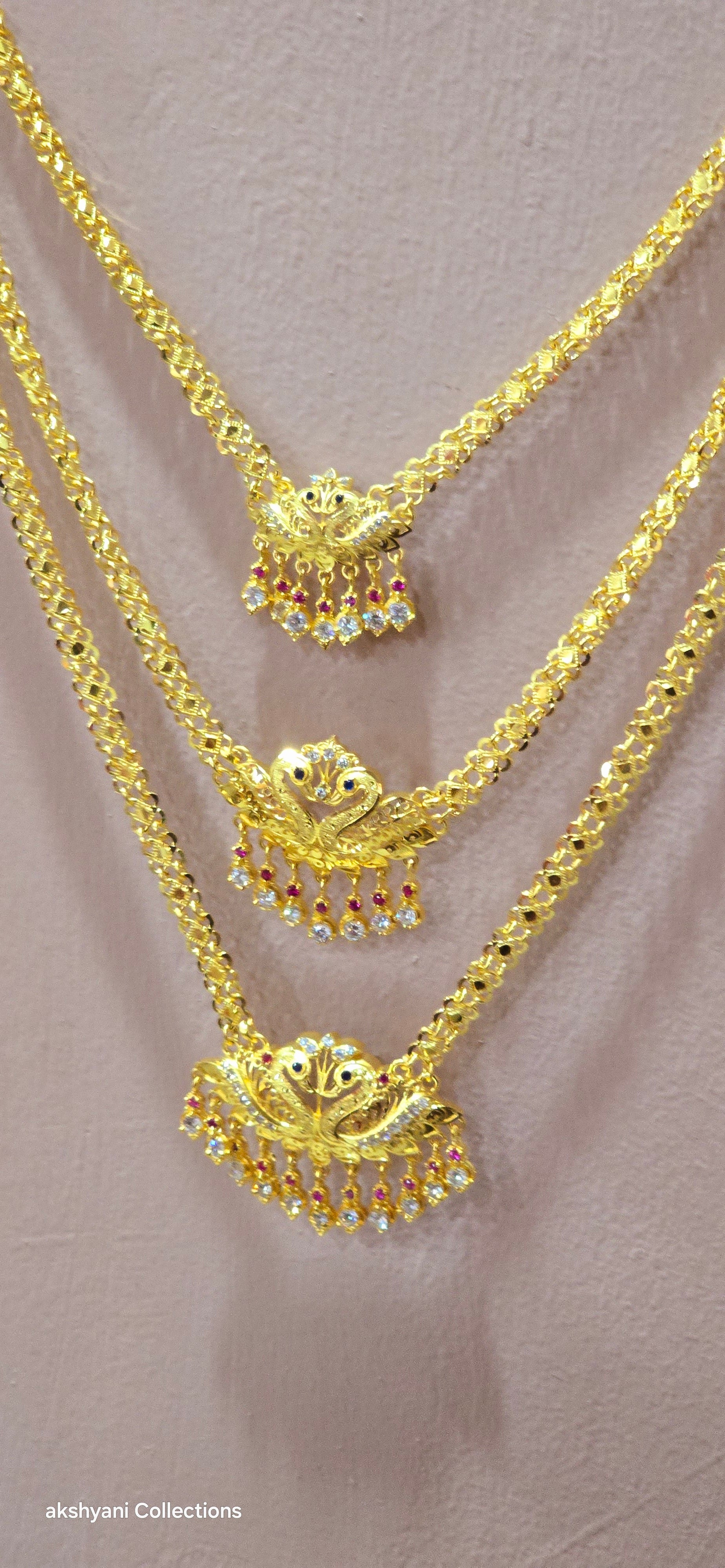 3 layer pendent chain not 916 gold. 28 inches length with decked peacock brooch. Code 808A.
