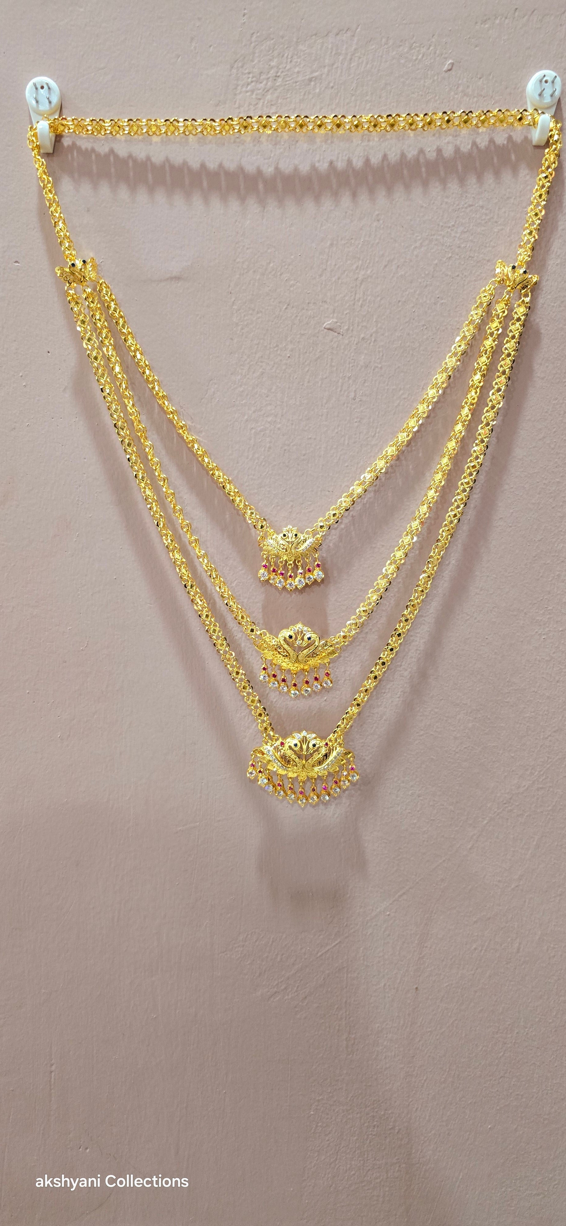 3 layer pendent chain not 916 gold. 28 inches length with decked peacock brooch. Code 808A.
