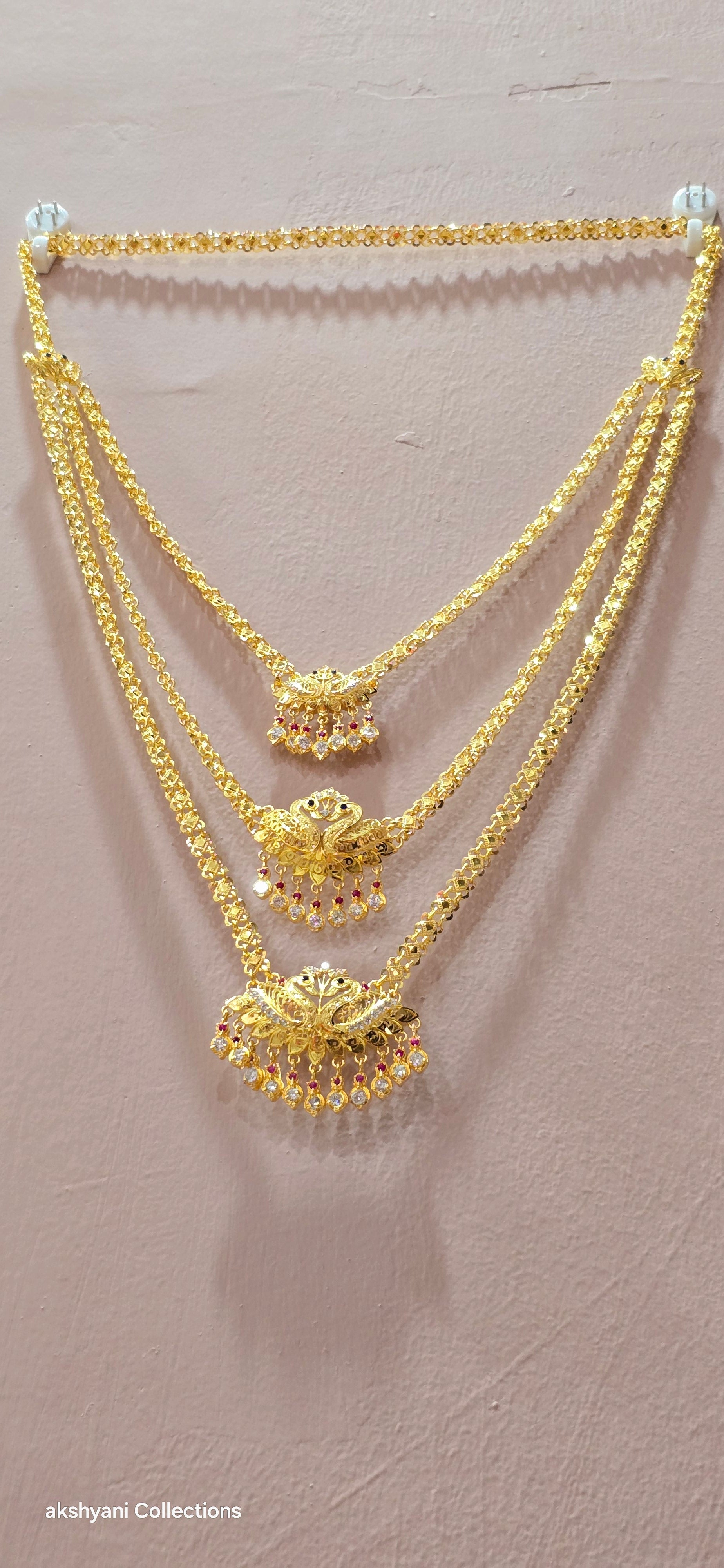 3 layer pendent chain not 916 gold. 28 inches length with decked peacock brooch. Code 808A.